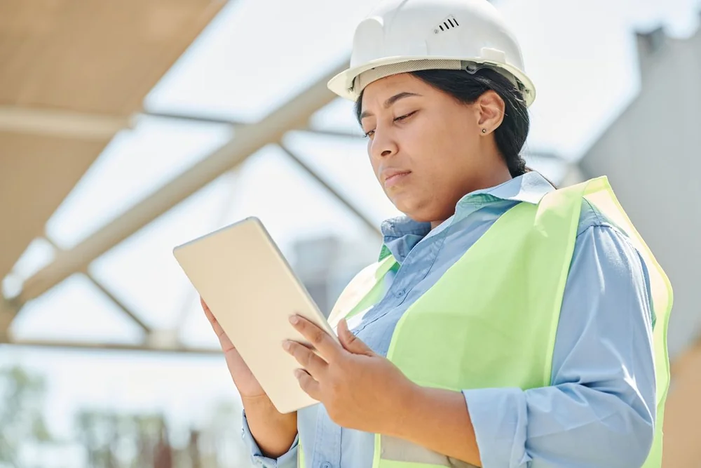 Field technician reviewing job information on a mobile device