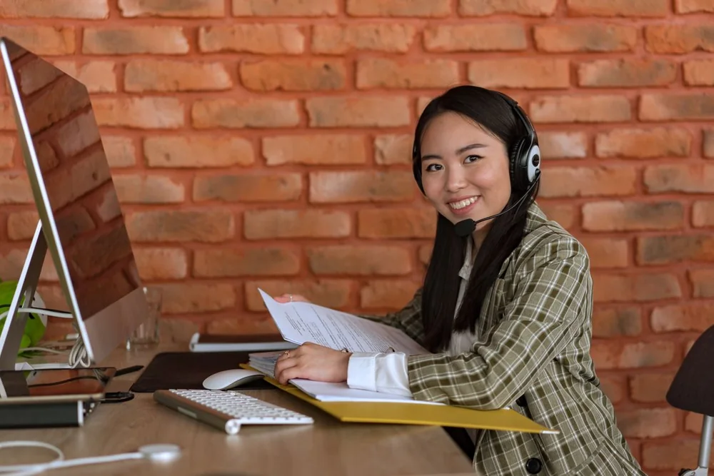 Office receptionist helping a customer by phone