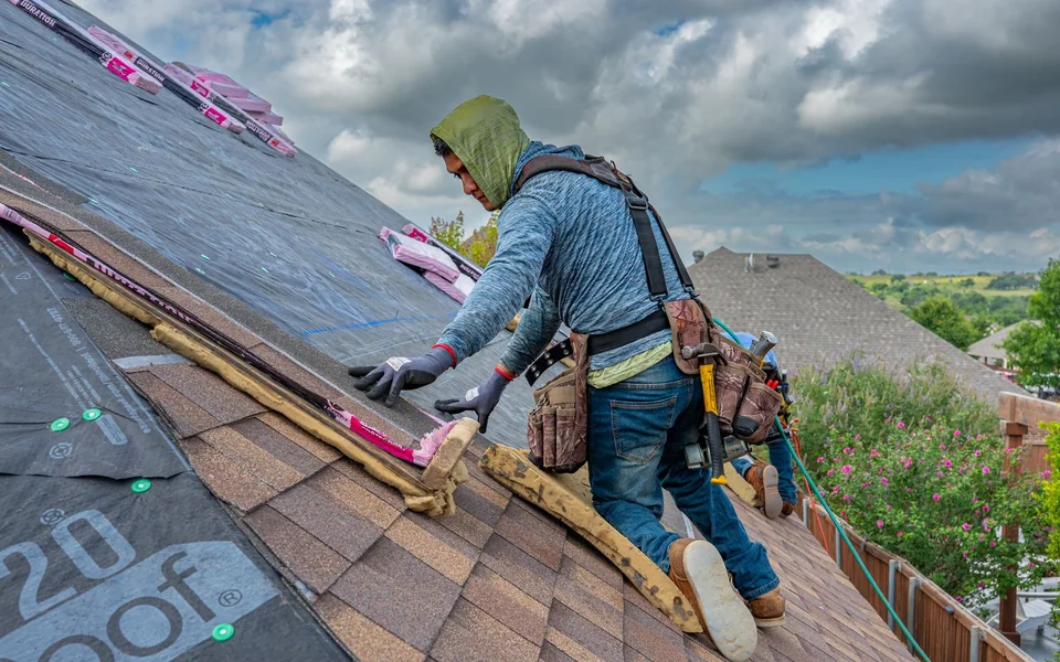 Roofing crew working on a residential roof